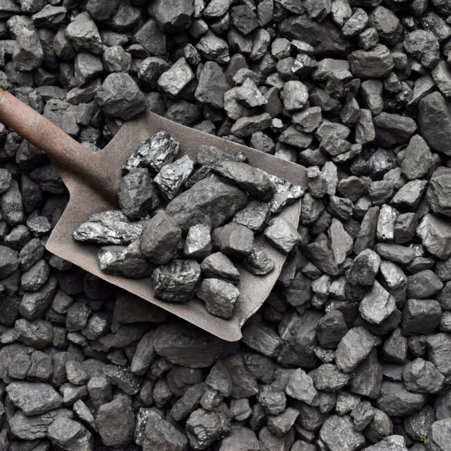 Shovel and coal in the background coal mine